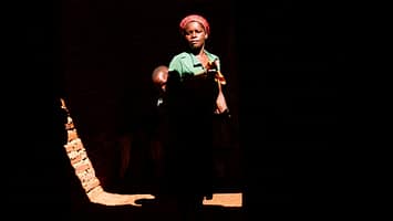 Sipiue Paulo stands with her son inside their home, which was partially destroyed by Cyclone Idai in 2019. One of the worst tropical storms to hit Southern Africa, the cyclone tore through Mozambique, Malawi and Zimbabwe, causing more than $2 billion in damage. Photo: Isabel Corthier/International Potato Center