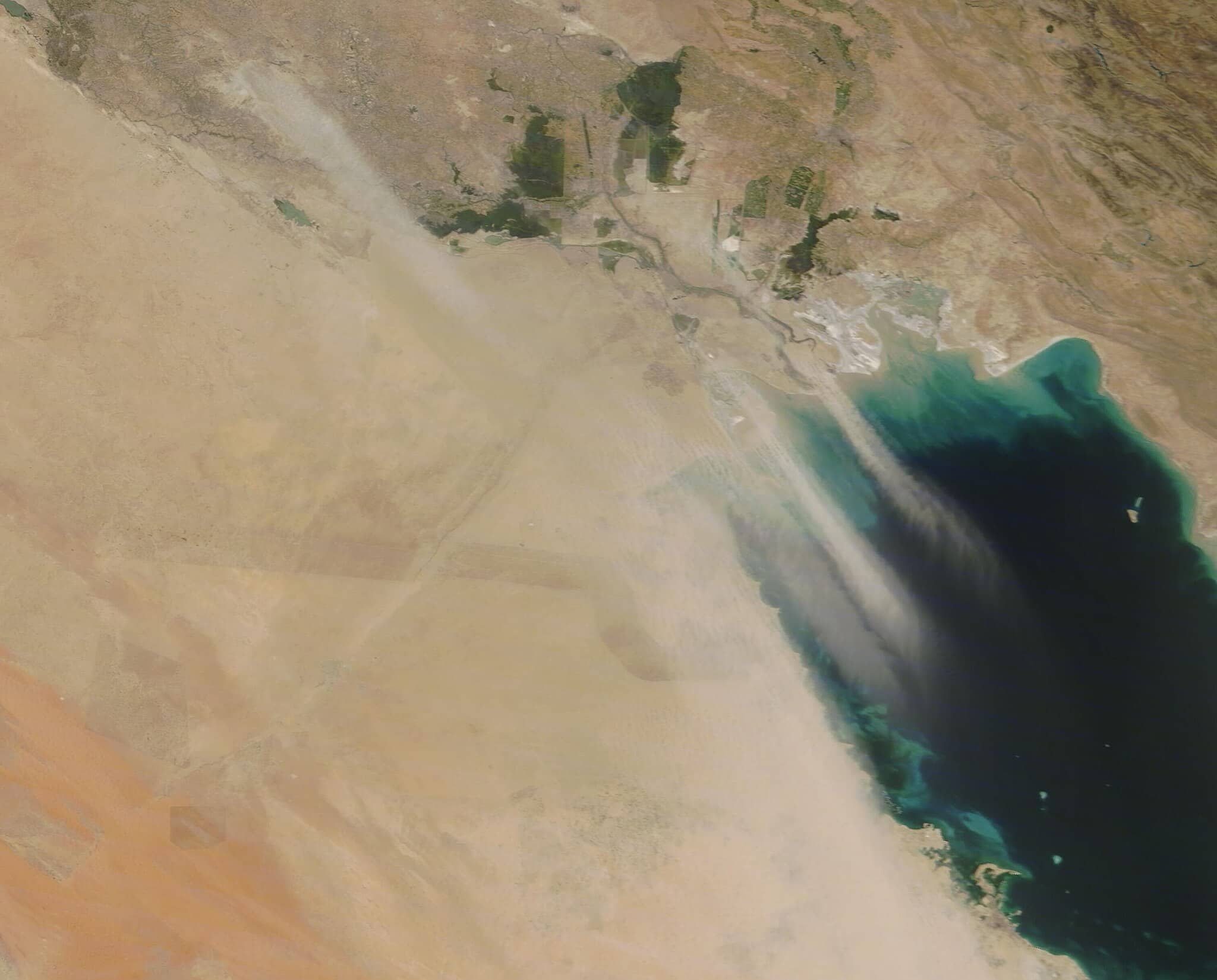 An intense sandstorm turned the skies over Kuwait orange on June 11, 2021, with long, thick plumes of sand stretching over Iraq, Kuwait and the Persian Gulf. Photo: MODIS Land Rapid Response Team, NASA GSFC via Wikimedia Commons
