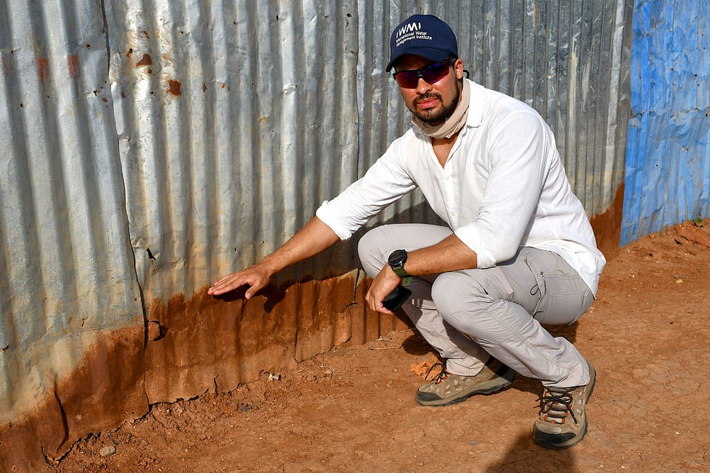 IWMI’s Mitchell McTough shows lowest flood levels in Dolo Ado town. Photo: Elizabeth Wamba/IWMI 