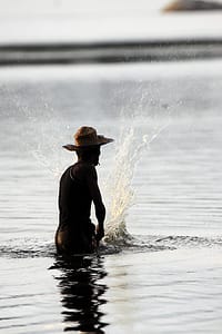 Fisherman beats the water to chase fish into nets at the Palatupana lagoon. This form of fishing is sustainable because it is practiced on a small scale. Photo: Sanjiv De Silva
