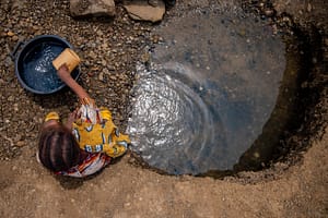 Girl fetching water from a dug out, Dumnazerbu, Adamawa State, Nigeria. Joe Bala / IWMI