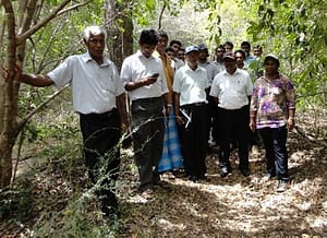 With farmers and officers on a field inspection for a suitable canal location 