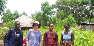 Dr. Gebrezgabher (third from left) and research partners meet with a Ugandan refugee woman in the Rhino Refugee Settlement. Photo: IWMI
