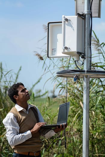 IWMI staff (Muhammad Khan Bhatti) inspecting an instrument installed on the Hakra 4L distributory 196, Hakra Branch Canal, Punjab, Pakistan.