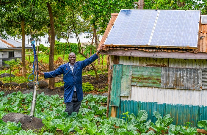 Maurice Owino, a smallholder farmer in Siaya County, Kenya, in his land. His solar-powered irrigation pump has boosted yields and increased resilience to drought. Photo: SunCulture