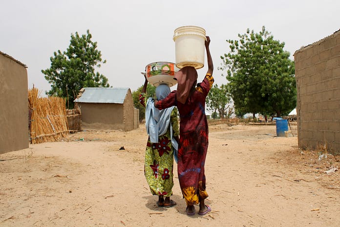 Girls returning home from fetching water from a well. Sangere, Nigeria. Photo: Rachael Michael