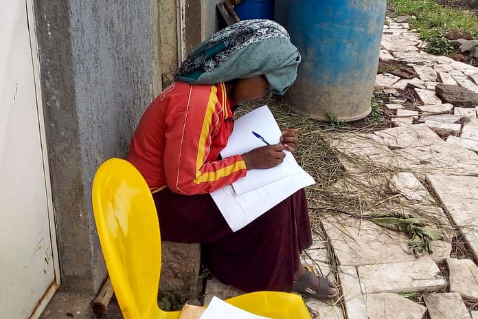 A citizen scientist journaling following a flood event in Akaki, Ethiopia. Photo: Tilaye Worku Bekele