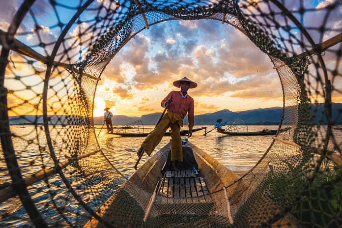 Inle Lake Intha fishermen at sunset in Myanmar. Photo: R.M. Nunes/Shutterstock