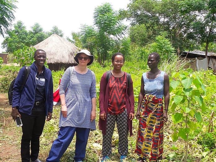 Dr. Gebrezgabher (third from left) and research partners meet with a Ugandan refugee woman in the Rhino Refugee Settlement. Photo: IWMI