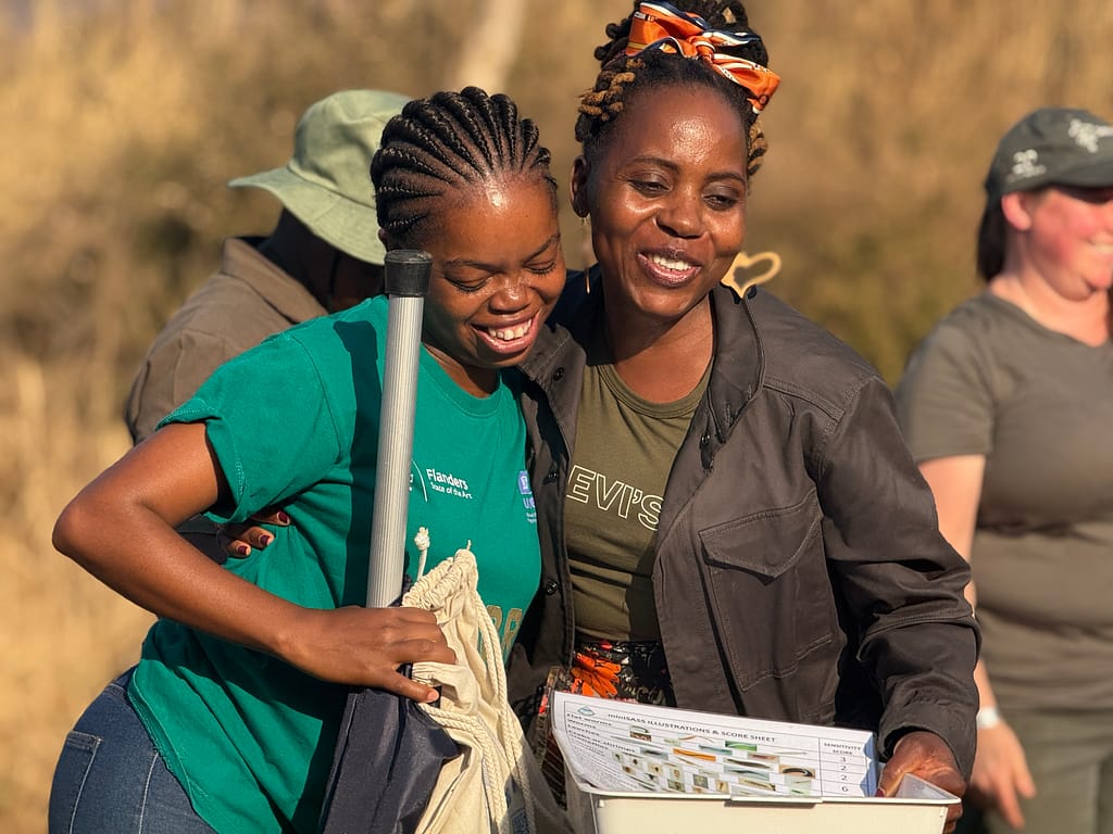 Volunteers in South Africa at a citizen science training. A trainee in Zimbabwe practices a water measurement method. Photo: Nkateko Langa/ IWMI