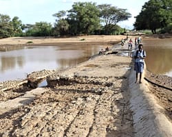 Flood damage is visible along the river Kawalasee and the nearby road as water recedes. Photo: Meron Teferi Taye/IWMI