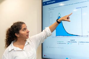 Mariangel Garcia Andarcia demonstrates the capabilities of the Limpopo Water Copilot to request water availability forecasts for specific locations within the Limpopo River Basin using natural human language. Photo: Pradeep Liyanage/IWMI