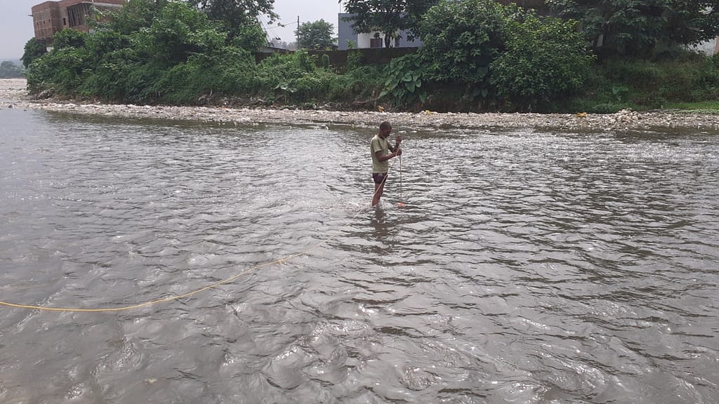 A research team member from Indian Institute of Technology Roorkee monitors water depth and velocity in the Song River in Uttarakhand. Photo: Niteesh Kumar Pandey/IIT Roorkee