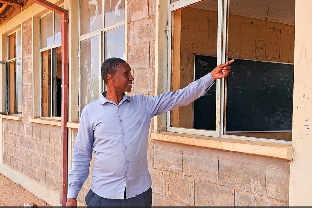 Dolo Ado Secondary School Director Adan Hassan Sambul shows the destruction of classrooms following the floods. Photo: Elizabeth Wamba/IWMI