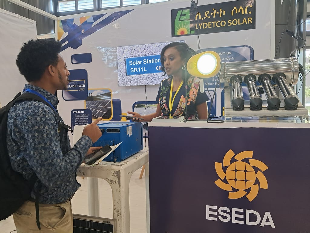 IWMI Research officer Desalegne Tegegne gathering information from ESEDA during the 2025 Ethio-Solar Trade Fair in Addis Ababa. Photo: Elizabeth Wamba/IWMI