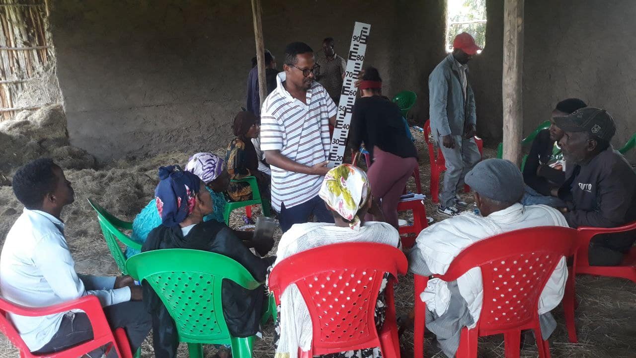 An IWMI research assistant explains how to measure river water levels to citizen scientists in South Sodo District of Central Ethiopia. Photo: Tilaye Worku / IWMI