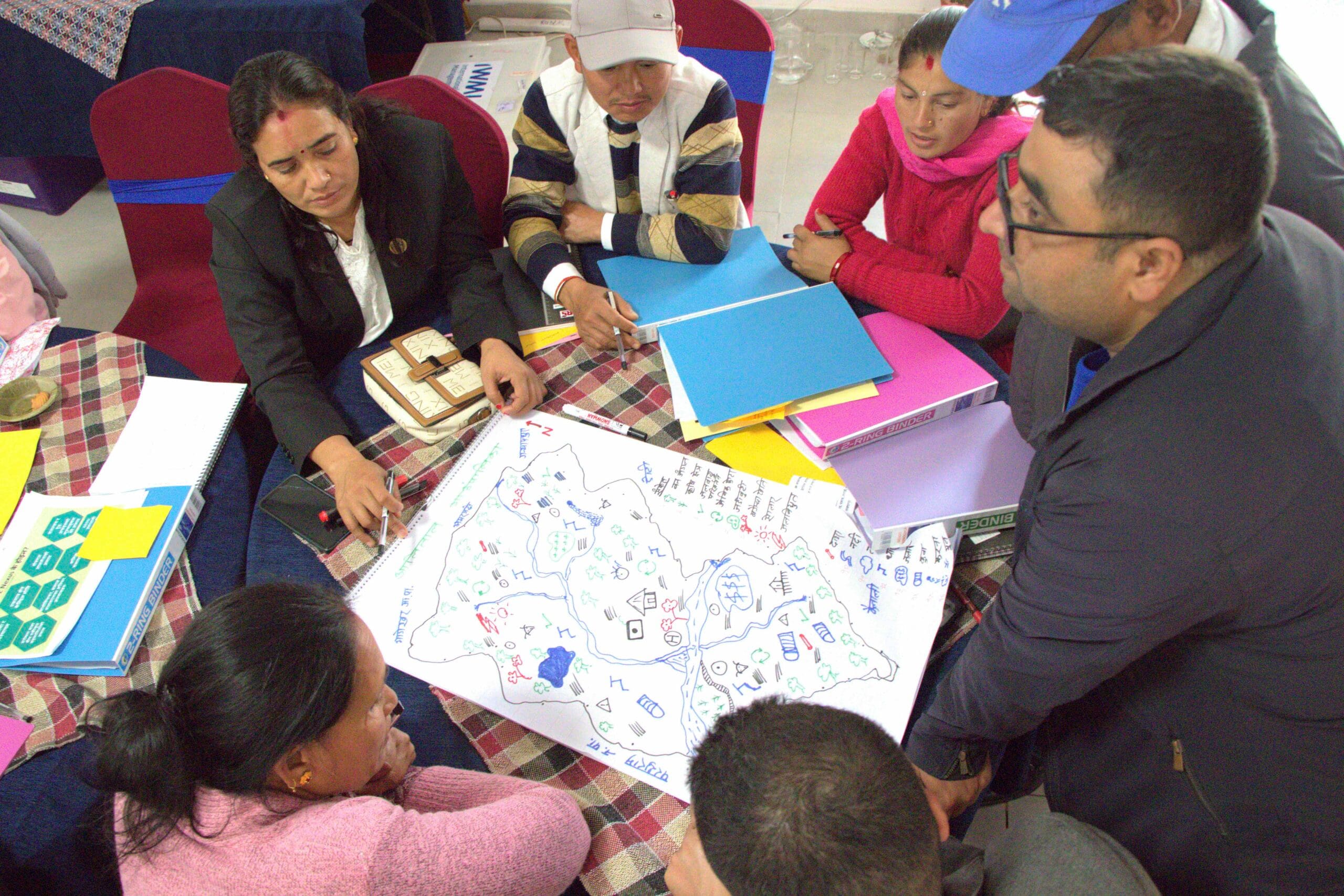 Participants sketching at the gender-responsive WEFE Nexus training for local representatives, municipality staff and women empowerment center members from the Rangun Watershed. Photo: Aayush Niroula/IWMI