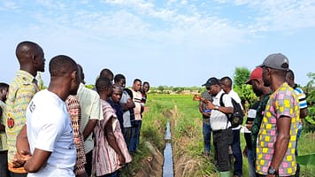 Adebayo Oke, (center right) senior regional researcher for Next Generation Irrigation Systems IWMI, during a filed visit in Botanga, Ghana. Photo: IWMI