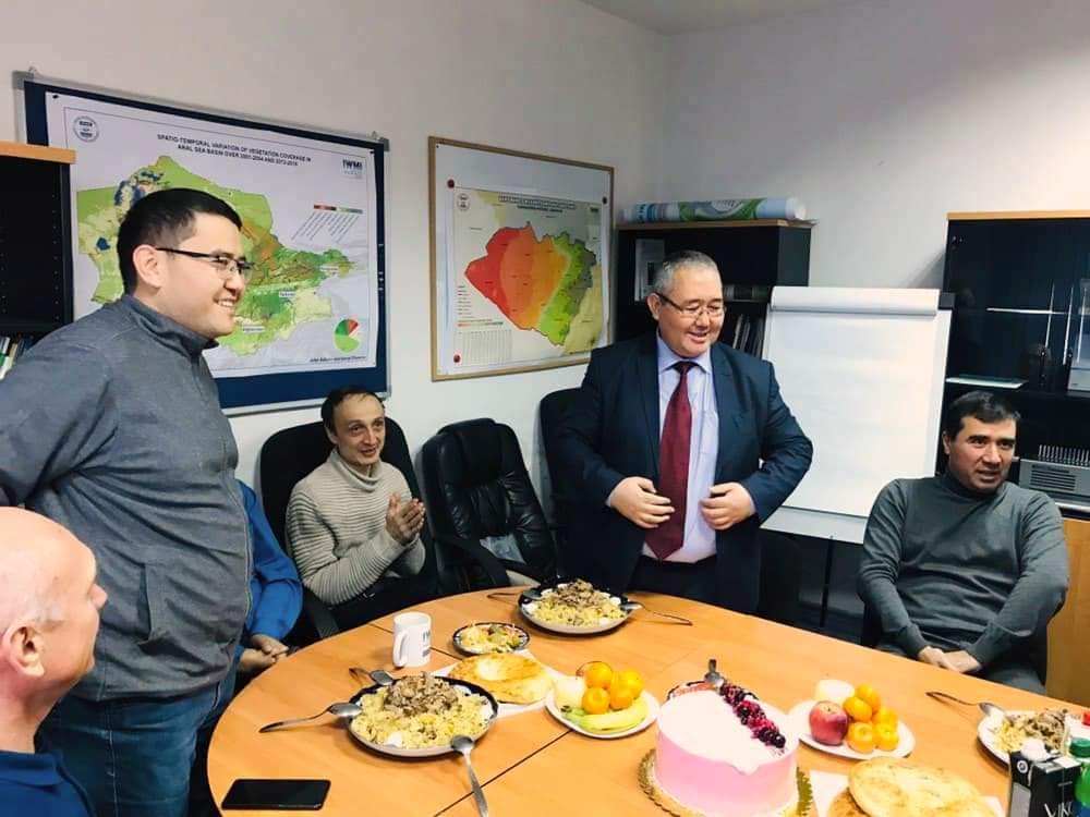 Kakhramon Djumaboev (center, standing) during a celebration at the IWMI office. Photo: Handout.
