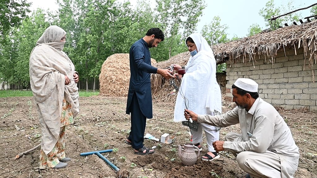 IWMI researchers install soil moisture sensors on a farm in Charsadda, Pakistan. Photo: Amjad Jamal/IWMI