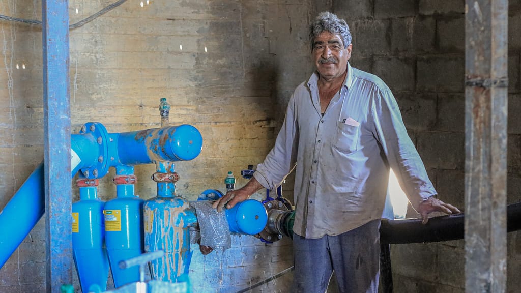 Farmer showing water reuse infrastructure for a vineyard in Bekaa, Lebanon. Photo: Lien Arits/IWMI