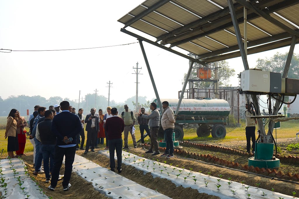 Delegations from Kenya, Ethiopia, and Bangladesh, along with IWMI researchers from India and SDC representatives, interact with scientists at an Agri-PV site at ICAR-KVK Ujwa, South West Delhi. Photo: Tanmoy Bhaduri/IWMI