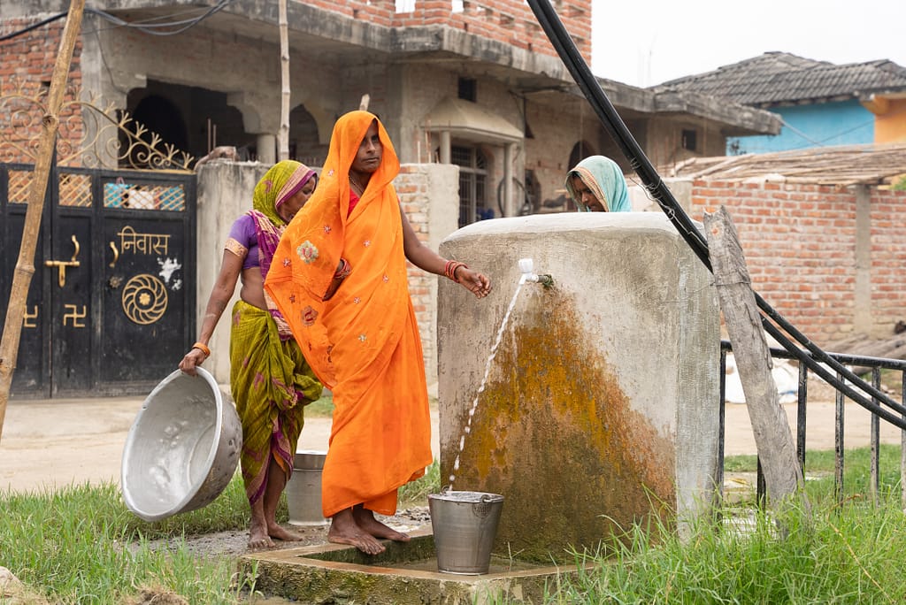 Women gather at a community tap to collect water for their daily needs in Sarlahi district, Nepal. Photo: SDG Studio for IWMI