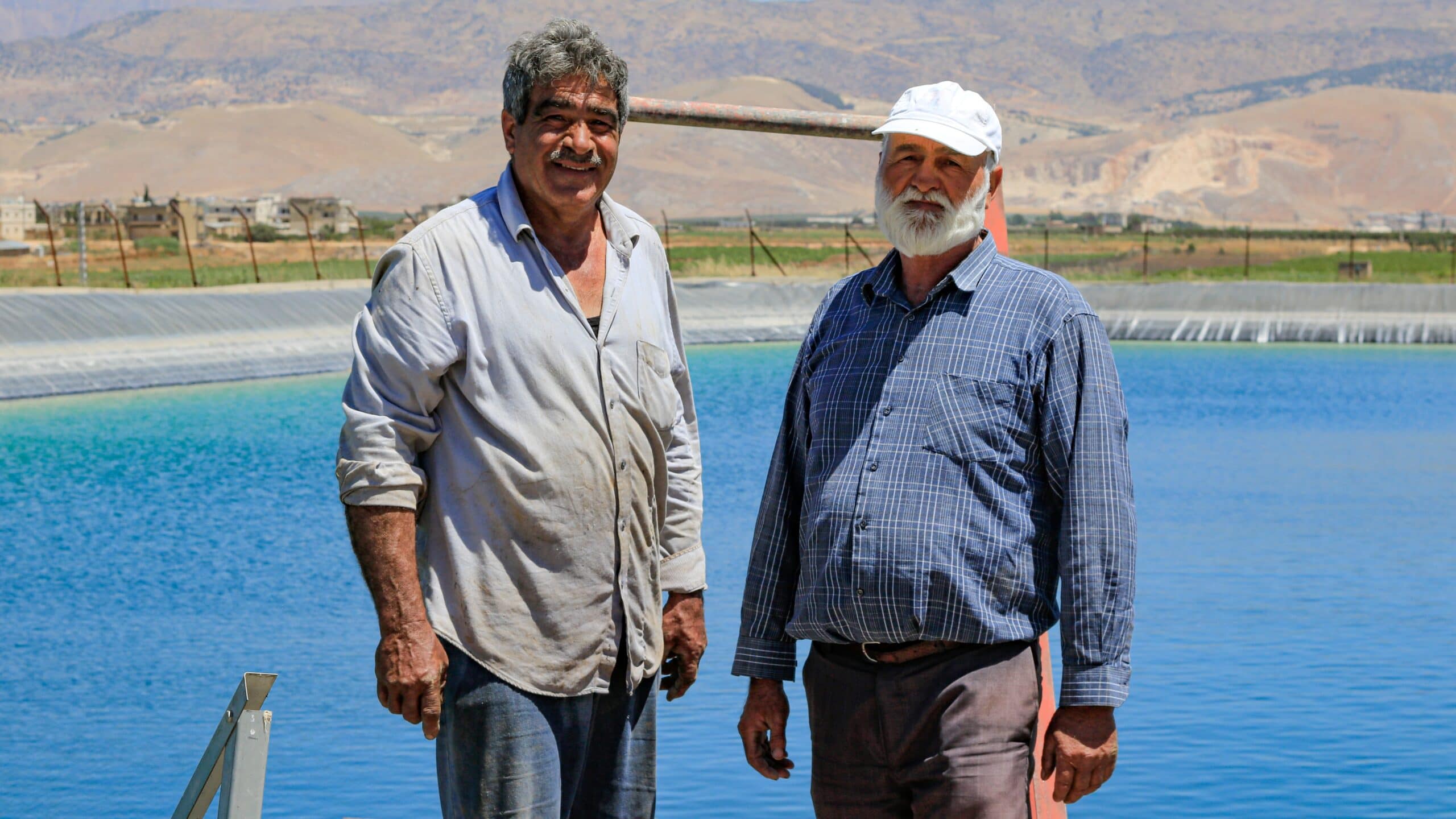 Wastewater treatment plants and farmers in Bekaa village, Lebanon. Farmers stand next to an artificial lake made for agricultural use. Photo: Lien Arits/IWMI
