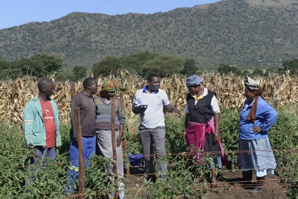 Luxon Nhamo shows the communal farmers how he goes about taking readings for the Geographic Information Systems and Remote Sensing.