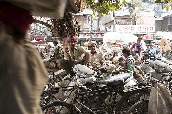 Workers take a break at Khari Baoli in Delhi. Banwari Singh Tohmat from Morena in Madhya Pradesh has been working for 30 years in the city. He has agricultural fields at home which he goes back to 3 to 4 times a year. Relatively few migrants, however, invest their remittances in agriculture. Photo: Ruhani Kaur
