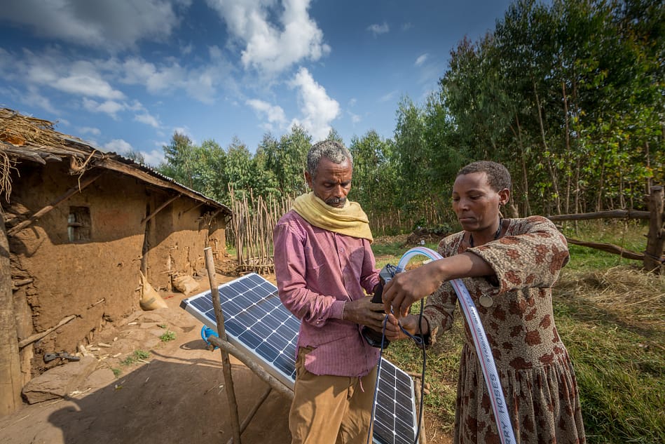 Sewagegn, a local smallholder farmer, and Gebeyaw, a data collector, set up Sewagegn's solar powered pump to irrigate her backyard garden in Danghesta, Amhara region of Ethiopia. Photo by Mulugeta AyeneWLE. Sewagegn, a local smallholder farmer, and Gebeyaw, a data collector, set up Sewagegn's solar powered pump to irrigate her backyard garden in Danghesta, Amhara region of Ethiopia. Photo by Mulugeta AyeneWLE.