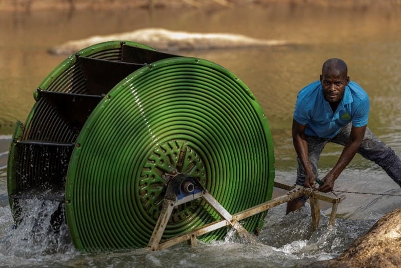 A farmer in Malawi installing a hydro-powered water pump. Photo: GIZ