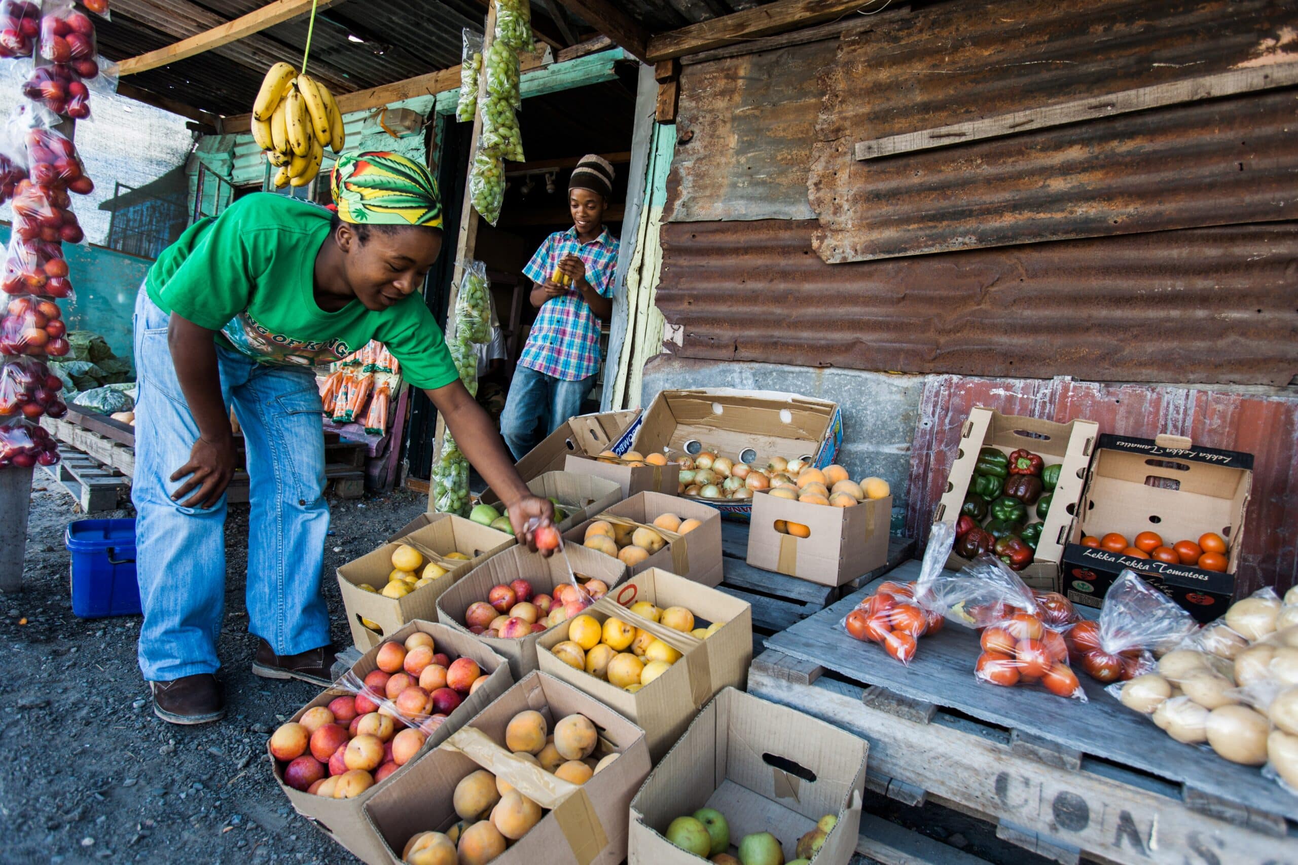 A shopkeeper sorts fruit at his food stall in Cape Town, South Africa. Photo: ImageArc/Shutterstock