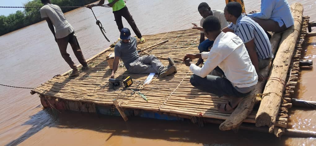 Tilaye crossing the river to conduct the bathymetry survey for the river cross section