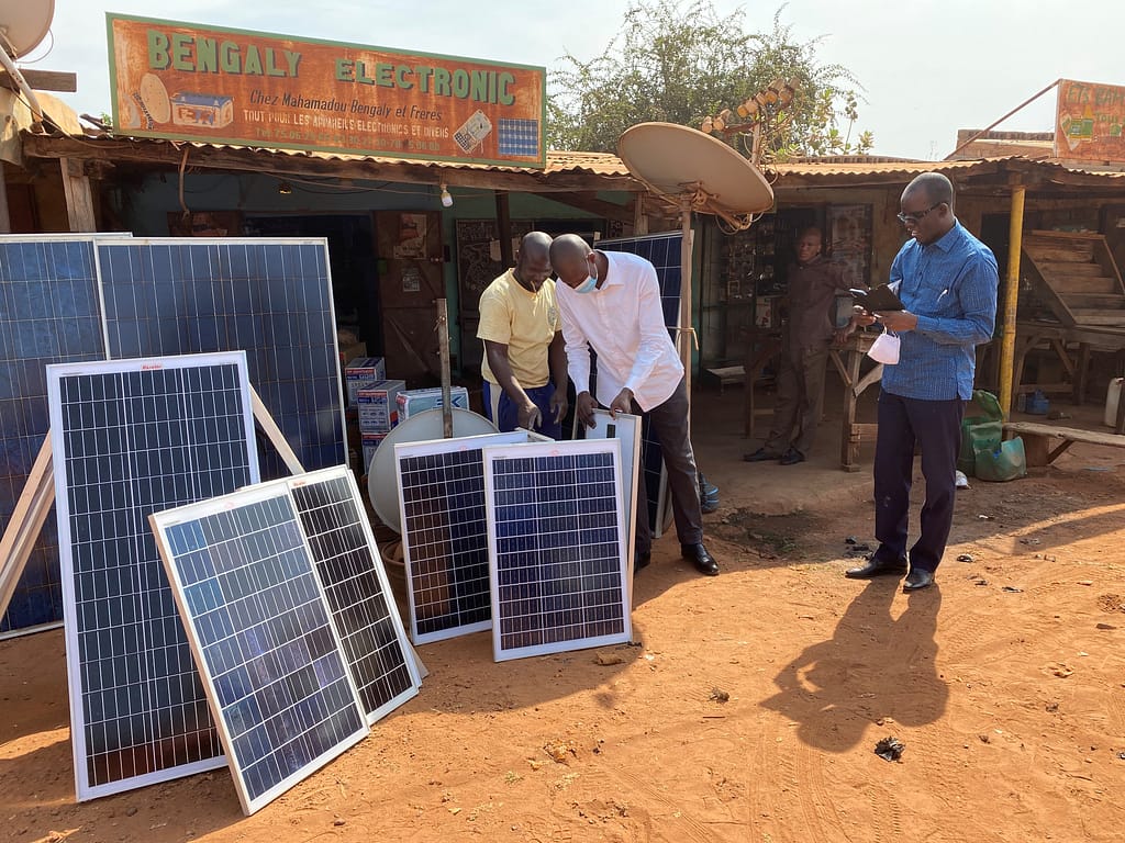 Tlamadou Bengaly (left) owns a shop selling solar panels in the city of Sikasso, Mali. Photo: Thai Thi Minh/IWMI