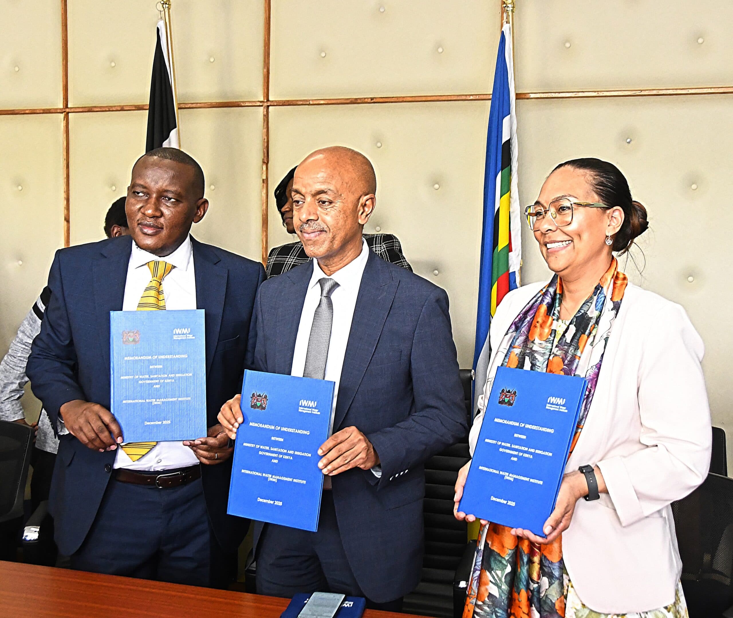 Kenya’s Irrigation Principal Secretary Ephantus Kimotho (Left) with IWMI’s Abdulkarim Seid and Inga Jacobs-Mata display the MoU document after signing in Nairobi, Kenya. Photo: Akhal Lorua/Ministry of Water, Sanitation and Irrigation, Kenya