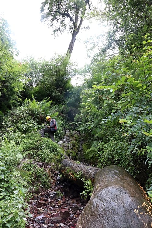 IWMI Field assistant measuring discharge at a spring in Shikharpur, Baitadi. Photo: Sanita Dhaubanjar / IWMI