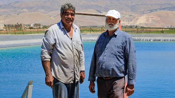 Wastewater treatment plants and farmers in Bekaa village, Lebanon. Farmers stand next to an artificial lake made for agricultural use. Photo: Lien Arits/IWMI