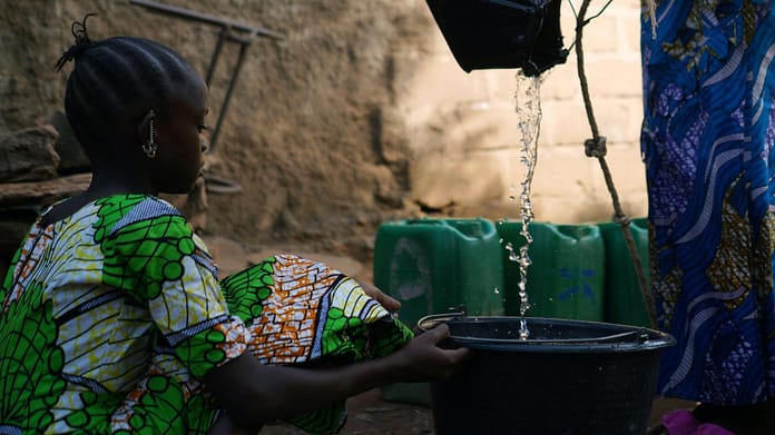 In many parts of the Global South, women and girls shoulder the primary responsibility for securing household water. Photo: Riccardo Lennart Niels Mayer/Alamy Stock Photo
