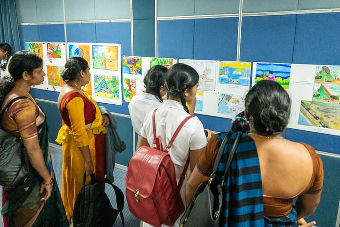 School children and teachers from the Nuwara Eliya district look at the art competition entries.