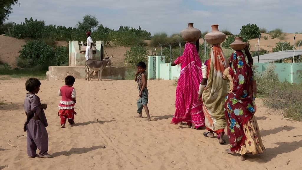 Women and children collecting water from a dug well in Gurri Village, Pakistan. Photo: IWMI