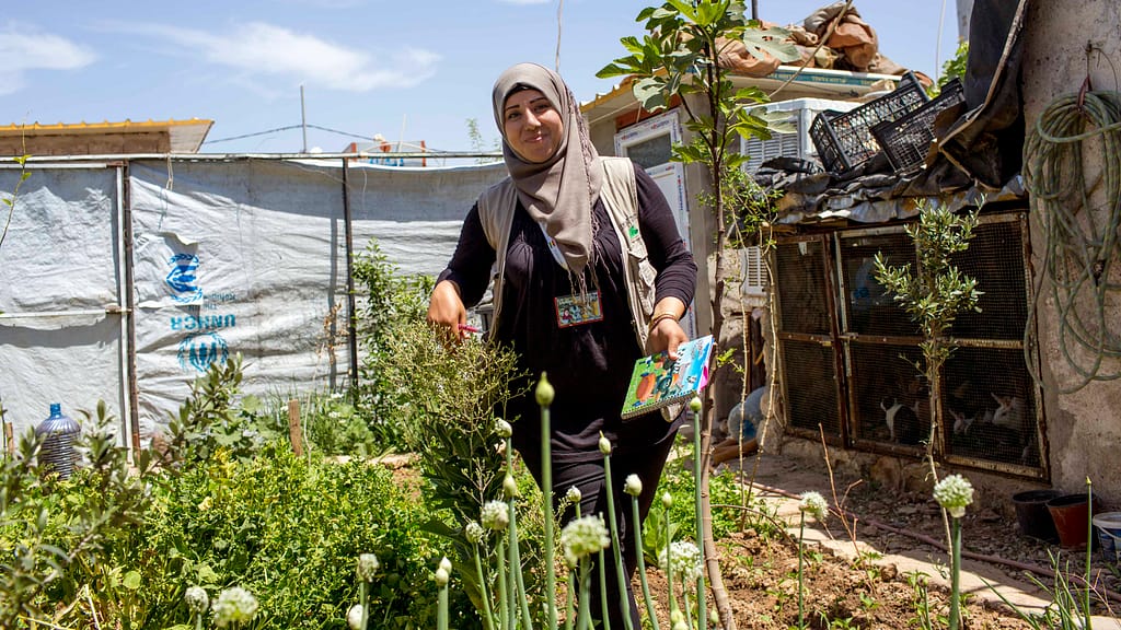 Woman standing in garden in Domiz refugee camp
