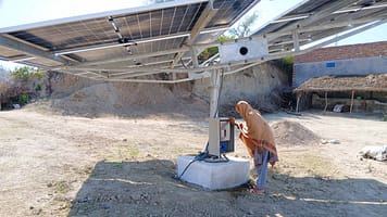 Nasreen operates the solar-powered irrigation system to water her crops with harvested rainwater on her farm in Chakwal, helping reduce dependence on unpredictable rainfall.