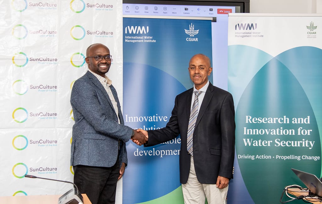 Patrick Mengo (left), SunCulture General Manager for Kenya, and Abdulkarim Seid, IWMI Regional Representative for East Africa, shake hands during the launch of the partnership in Nairobi. Photo: SunCulture 
