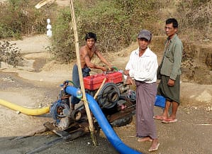 Villagers pumping from a sand dam to their village pond