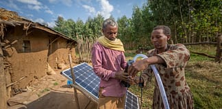 Sewagegn, a local smallholder farmer, and Gebeyaw, a data collector, set up Sewagegn's solar powered pump to irrigate her backyard garden in Danghesta, Amhara region of Ethiopia. Photo by Mulugeta AyeneWLE.