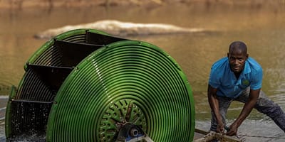 A farmer in Malawi installing a hydro-powered water pump. Photo: GIZ