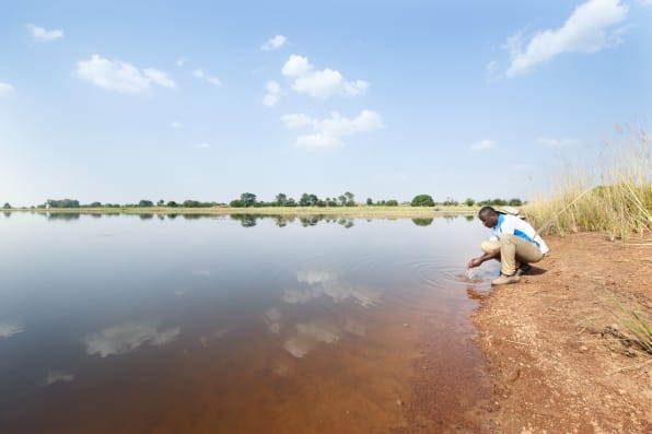 A man at the edge of a irrigation dam in the Northern Region, Golinga.