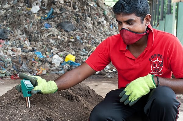 Kurunegala, Sri Lanka. Researcher Lakshika Hettiarachchi measures compost temperature at an RRR pilot site. Careful monitoring of the composting allows the researchers to fine tune the process, to create an optimal product.  The IWMI project in Sri Lanka is working with the Sri Lankan government to improve septic tank management practices and to convert fecal sludge into fertilizer pellets. Photo: Hamish John Appleby