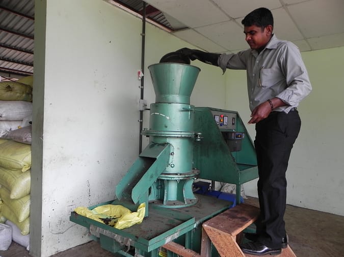 The compost is fed into the machine that compresses it into pellets.